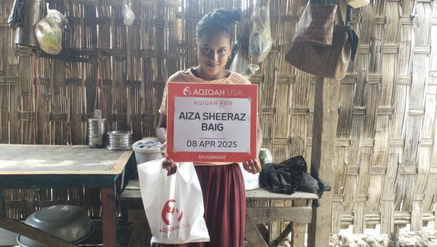 Young woman in Myanmar receiving Aqiqah meat donation from Aqiqah USA program