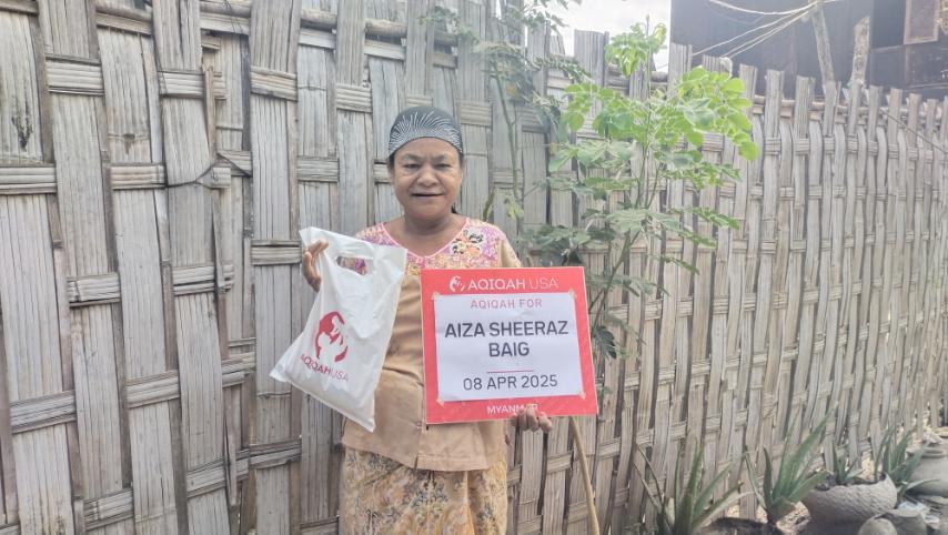 Muslim family member in Myanmar receiving Aqiqah meat package with gratitude